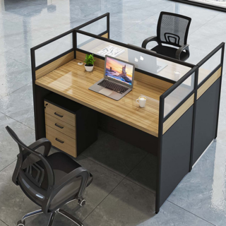 A modern office workstation with two desks facing each other, connected by a central divider with storage compartments and cable management features.