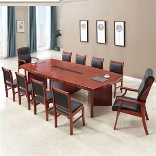 A modern 10-Seater Office boardroom table with a walnut finish and metal legs, set in a bright conference room.