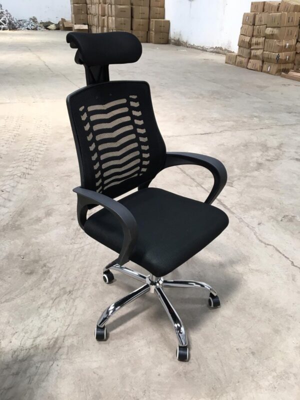 An ergonomic office chair with a headrest, adjustable features, and a sleek design, placed in a modern office setting.