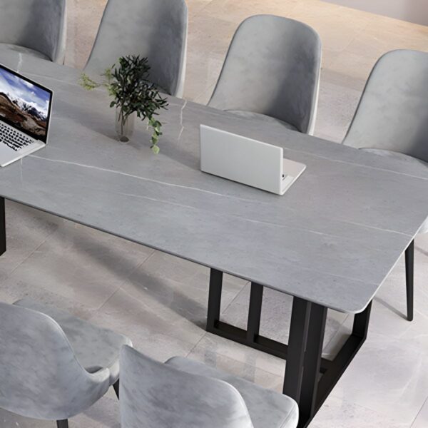 Modern office meeting table with a sleek design and ample workspace in a professional setting.