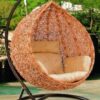 Cozy outdoor hammock swing hanging between two trees, inviting relaxation in a sunny garden.