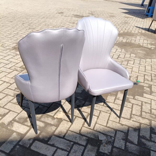 Modern Marble Leather Dining Chairs featuring a sleek design and marble-patterned upholstery in an elegant dining room setting.