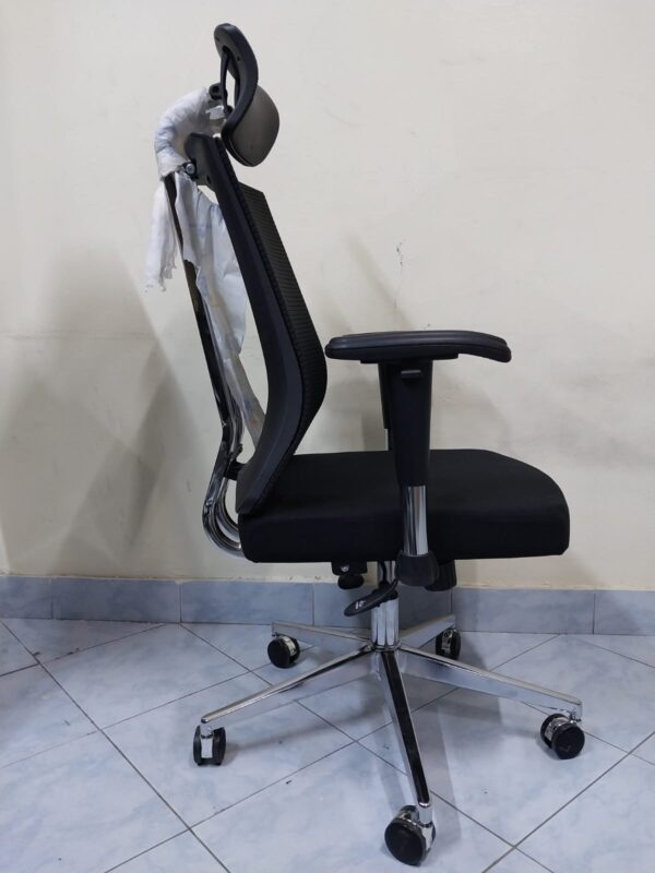 Black Orthopedic Seat with Lumbar Support placed in a modern office setting, showcasing its ergonomic design.