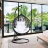 Cozy outdoor hammock swing hanging between two trees, inviting relaxation in a sunny garden.