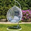 Cozy outdoor hammock swing hanging between two trees, inviting relaxation in a sunny garden.