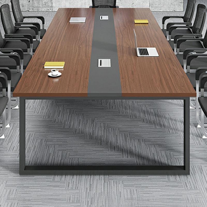 "Brown modern boardroom table with sleek design and elegant wood finish."