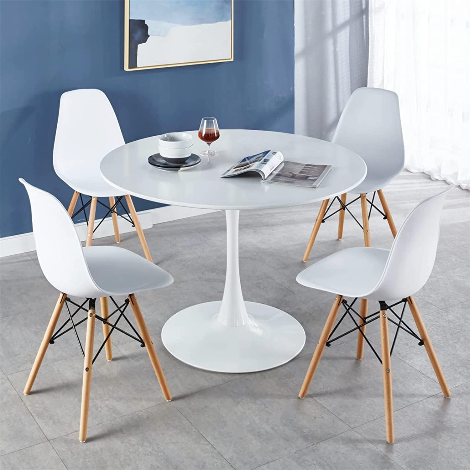 "Modern 4-seater white Eames dining set with sleek chairs and a minimalist table design."