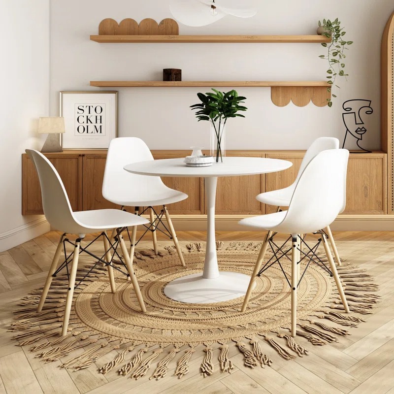 Tulip Table and 4 Eames Chairs set, featuring a minimalist design with a sculptural pedestal base and ergonomic molded plastic chairs in a modern dining space.