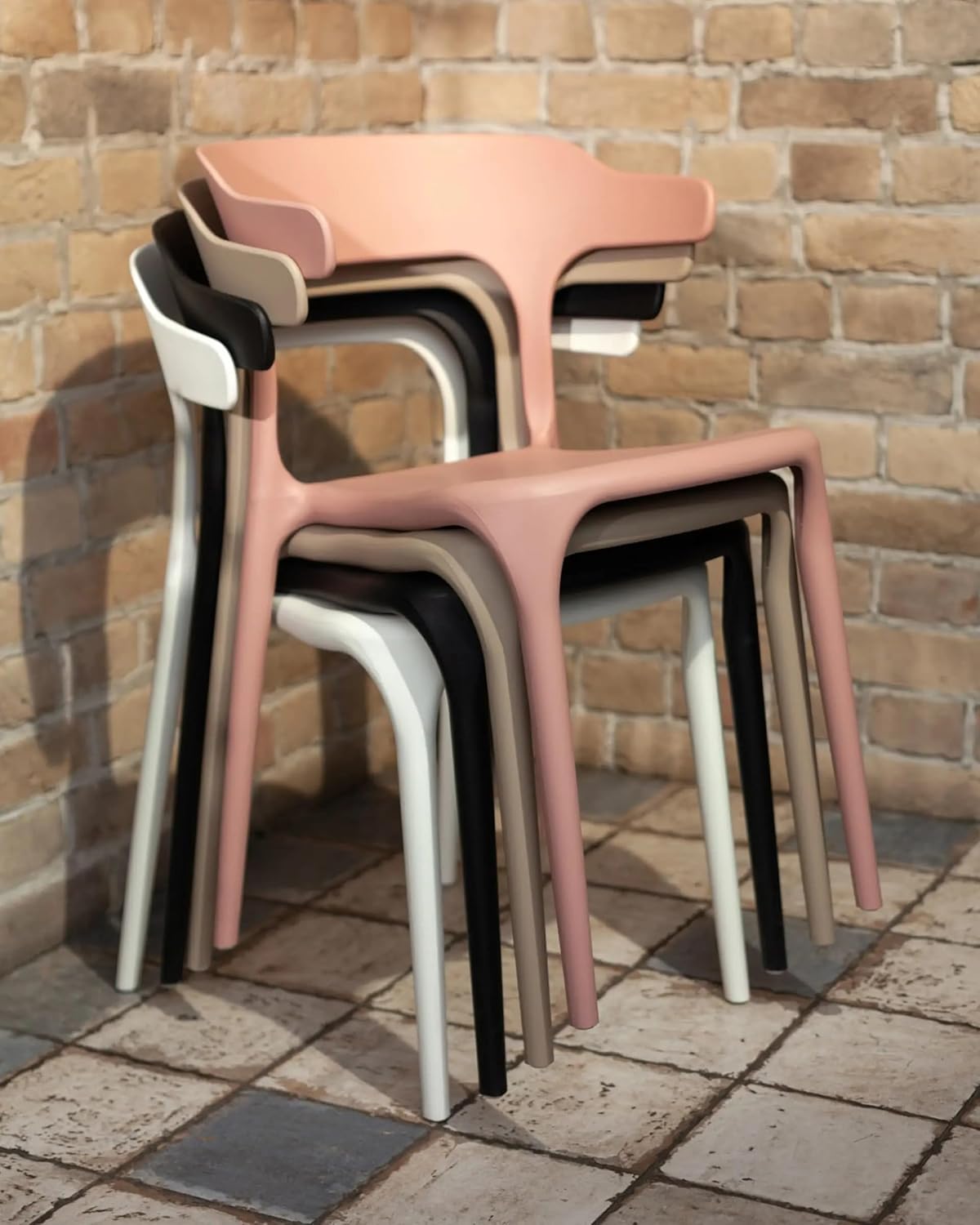 Plastic armless dining chair with a modern, stackable design for indoor and outdoor use.